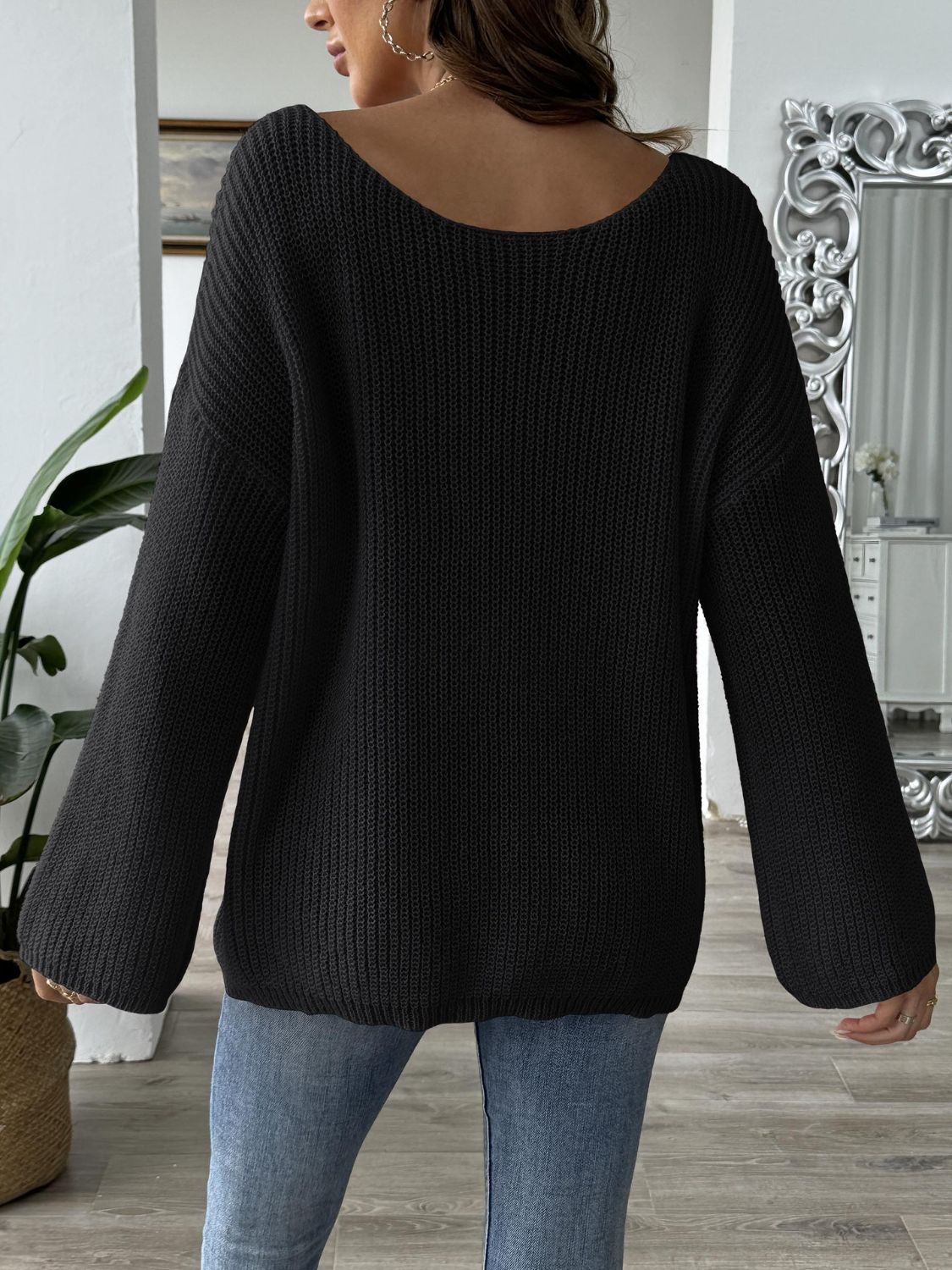 Black bow boat neck long sleeve sweater, slightly stretchy polyester, casual fit.