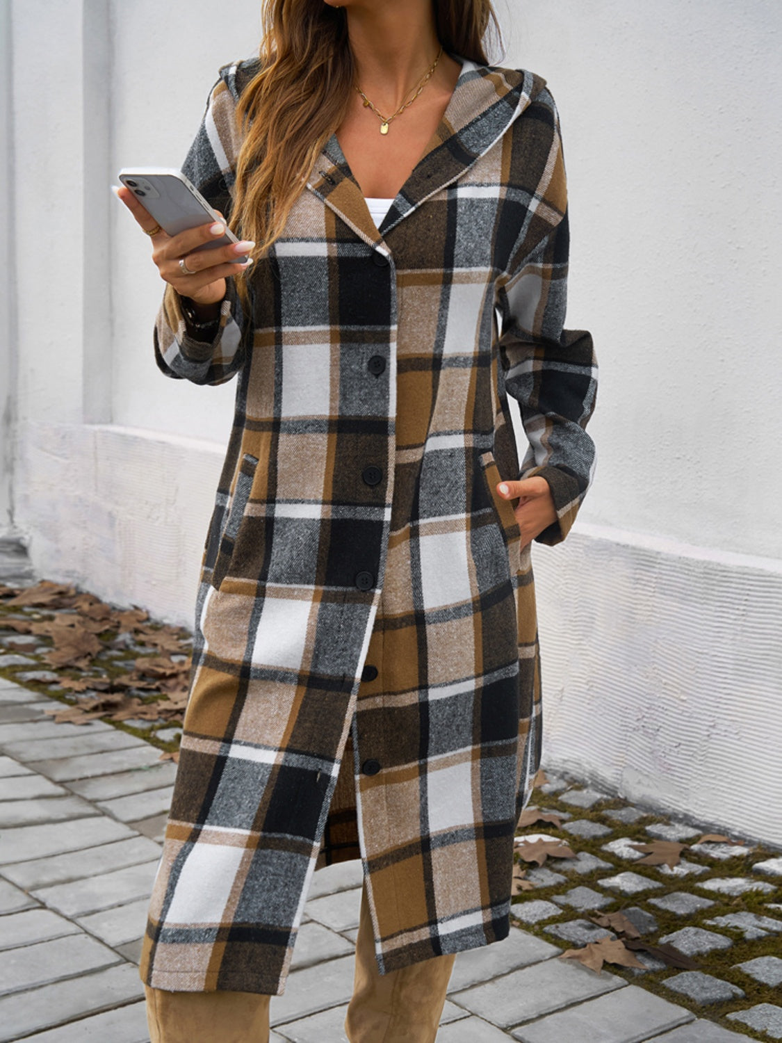 Plaid long sleeve hooded coat with buttoned front and pockets.