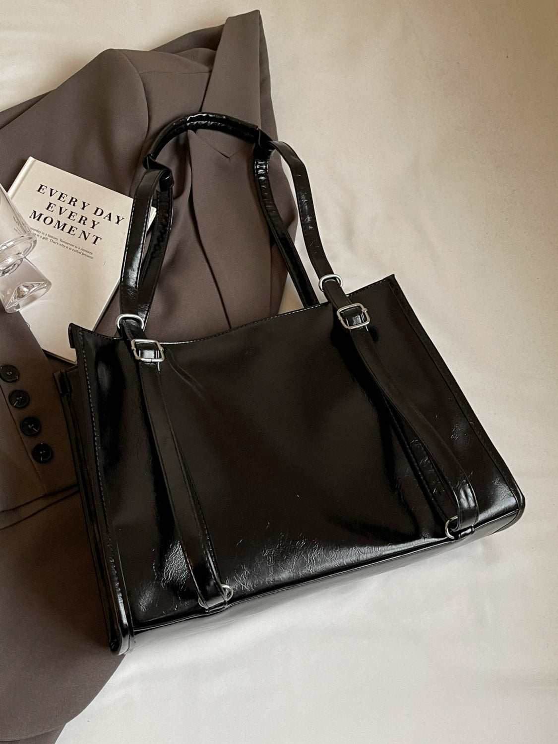 PU leather bow shoulder bag with spacious design in black.