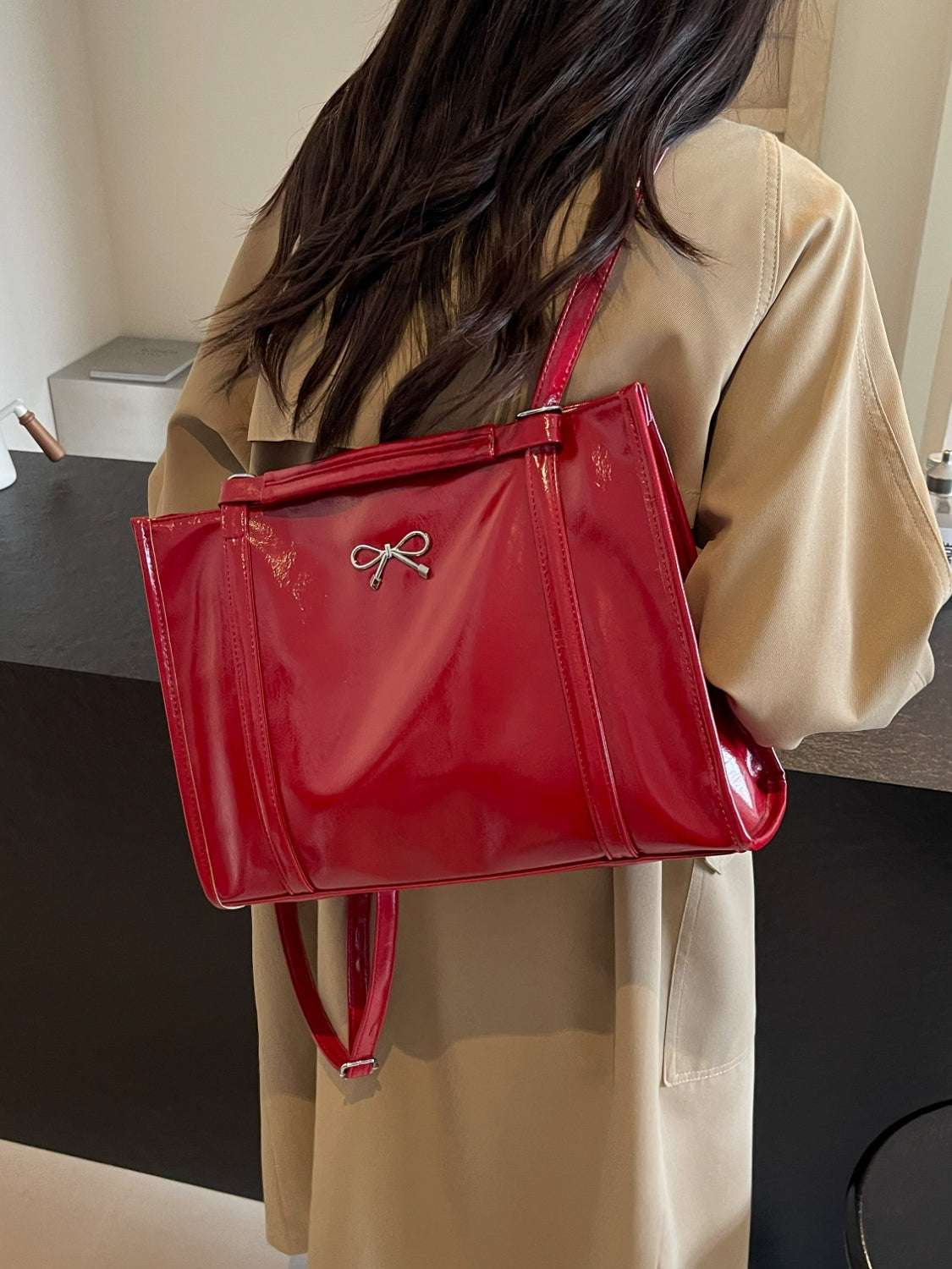 Red PU Leather Bow Shoulder Bag worn by model, spacious design for daily essentials.