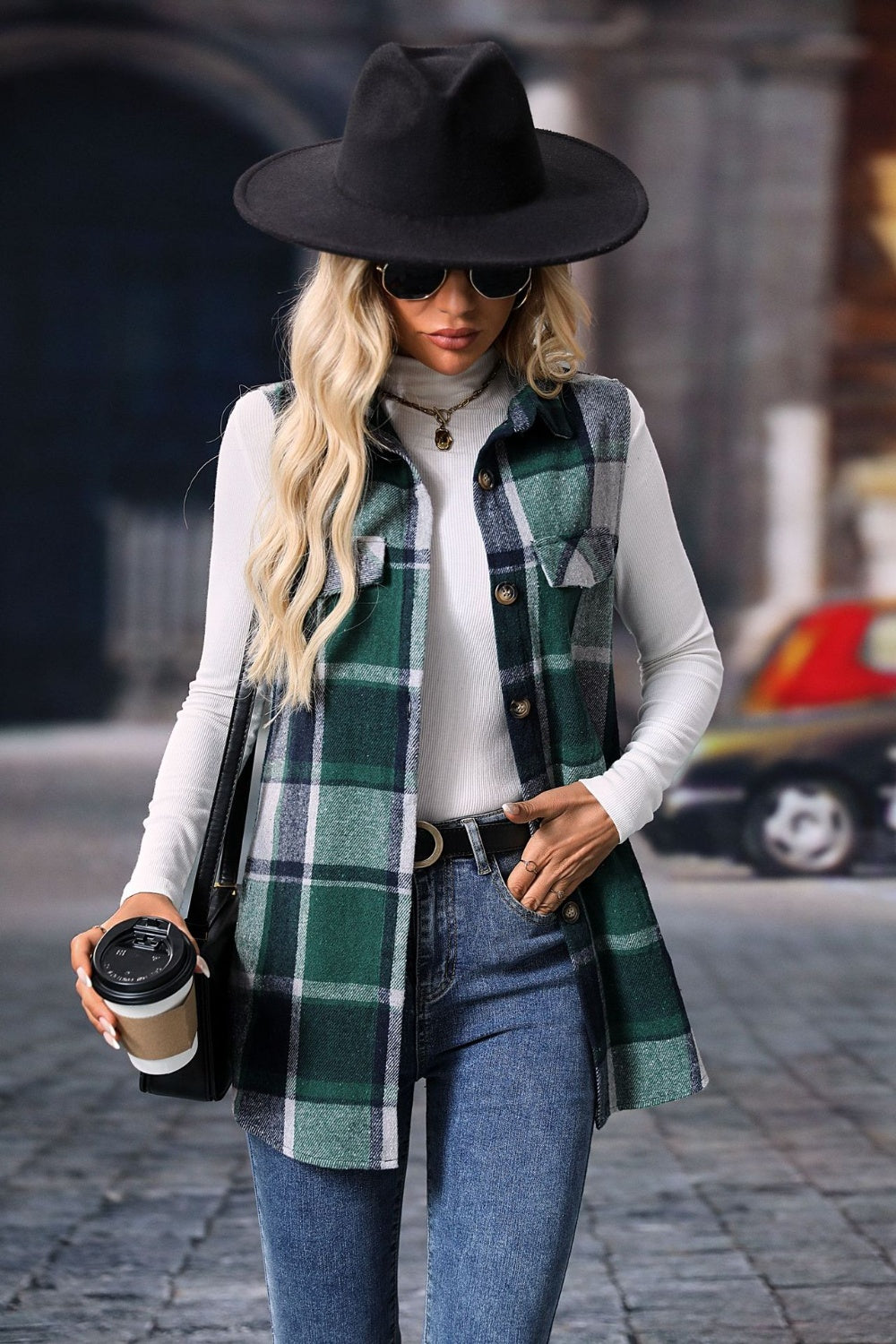 Plaid button-up vest coat with green and black pattern, featuring buttoned front, worn by model with black hat and sunglasses.