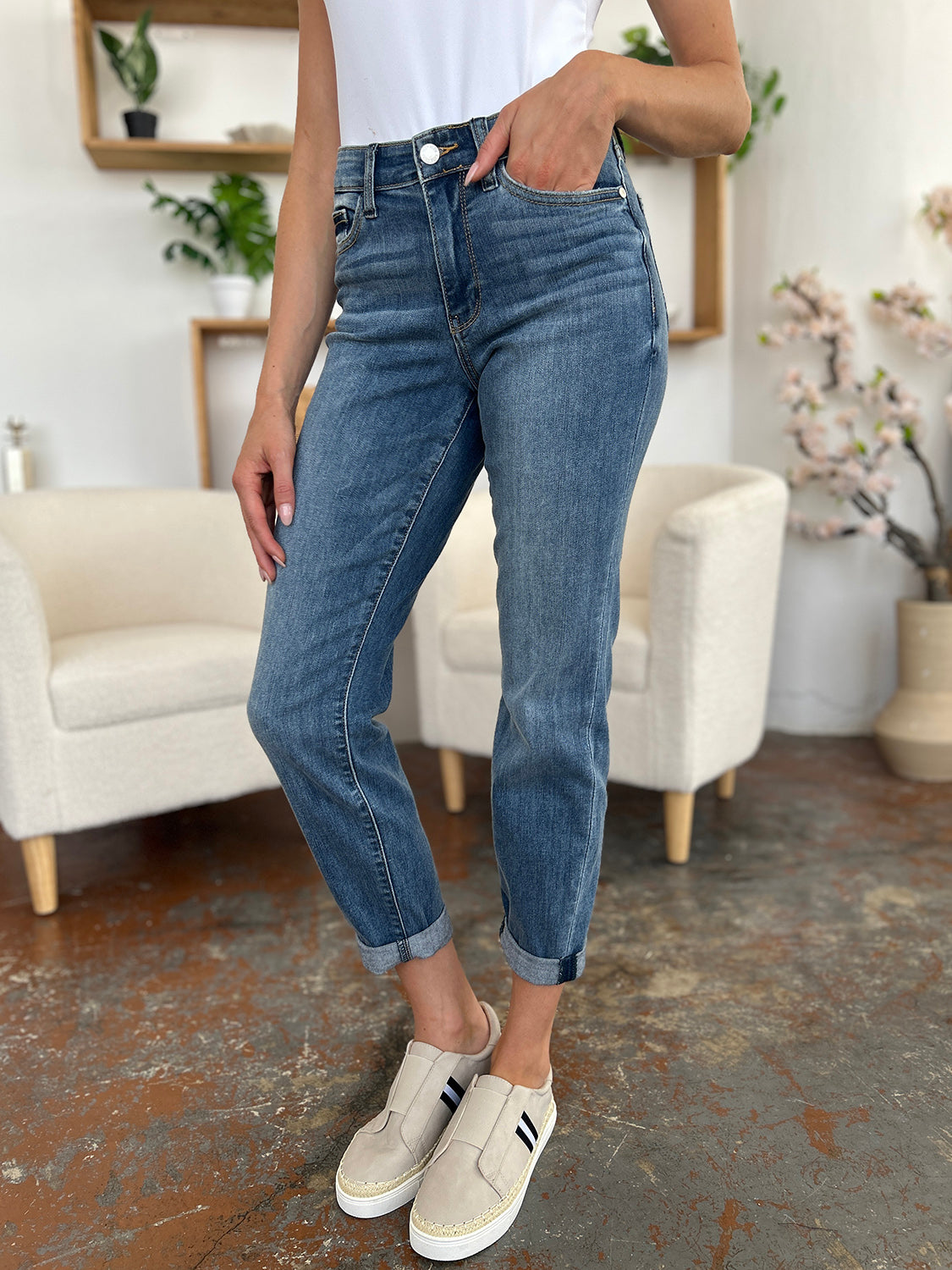 Judy Blue Full Size Cuffed Hem Slim Jeans on model with sneakers in casual setting.