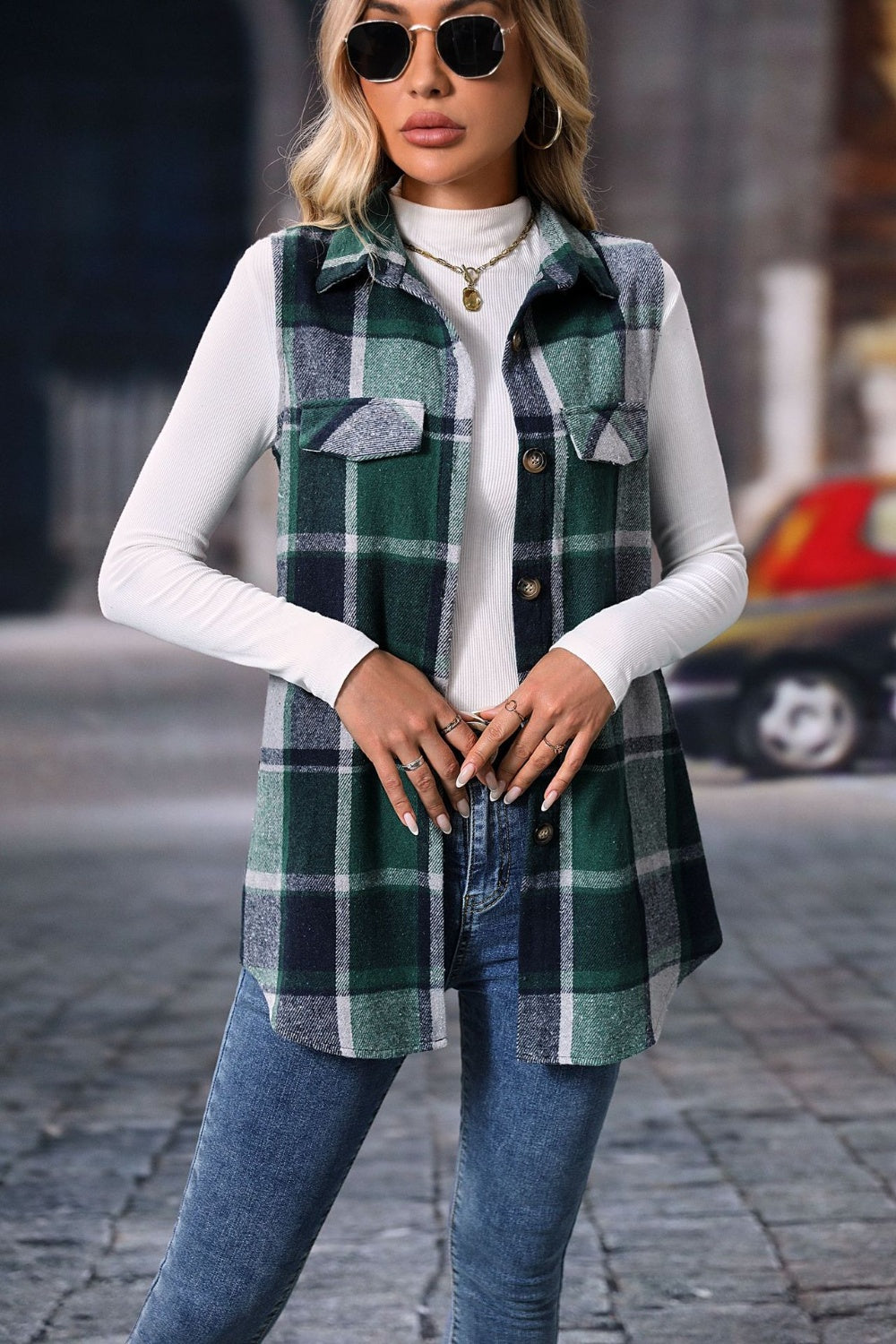 Plaid button-up vest coat, green and black checkered pattern, layered over a white turtleneck shirt.