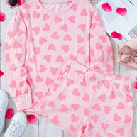 Heart print long sleeve top and shorts lounge set in pink on display with accessories.