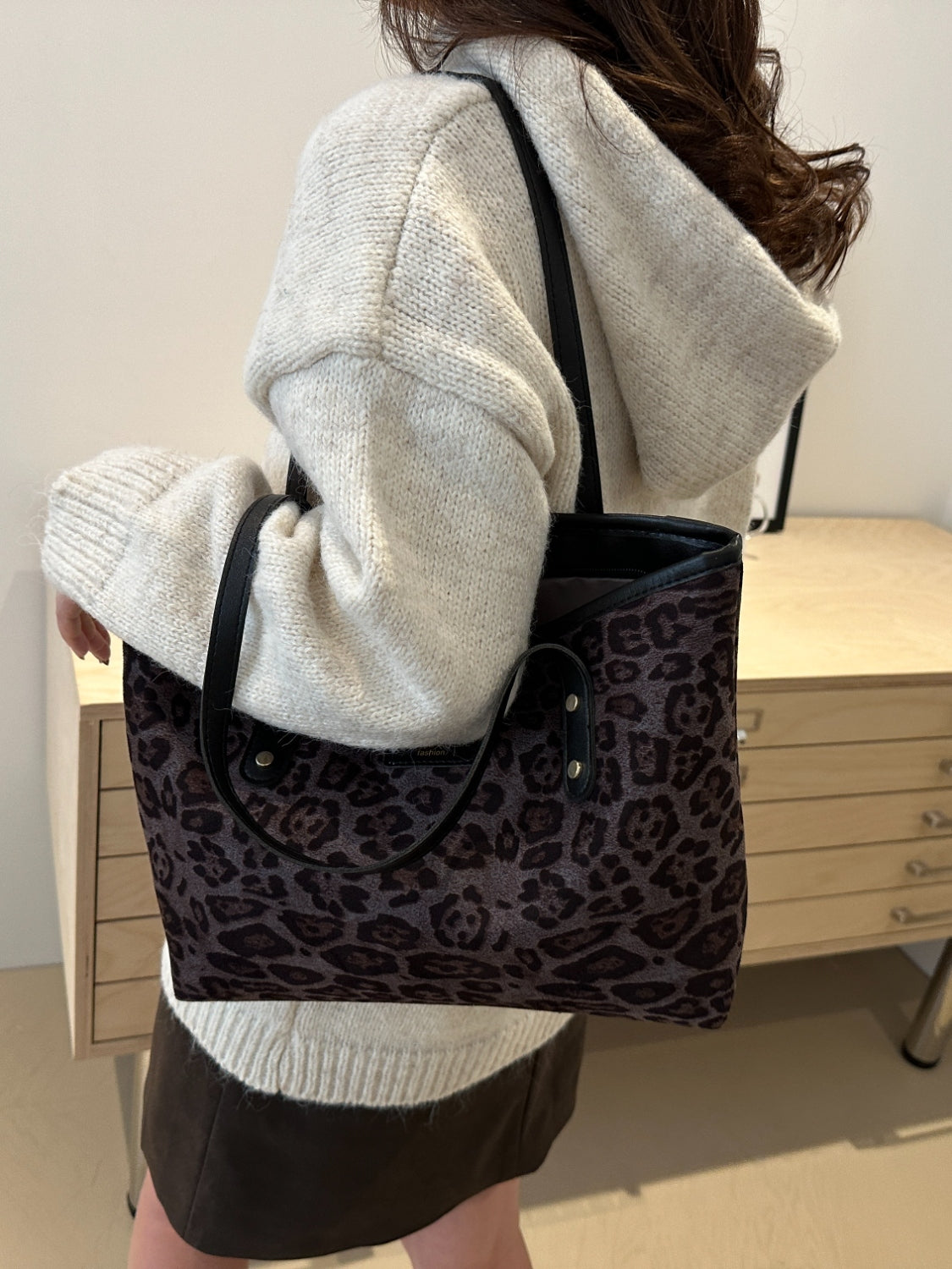 Leopard polyester tote bag, large size, worn by person, shown in indoor setting.