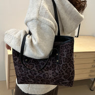 Leopard polyester tote bag, large size, worn by person, shown in indoor setting.