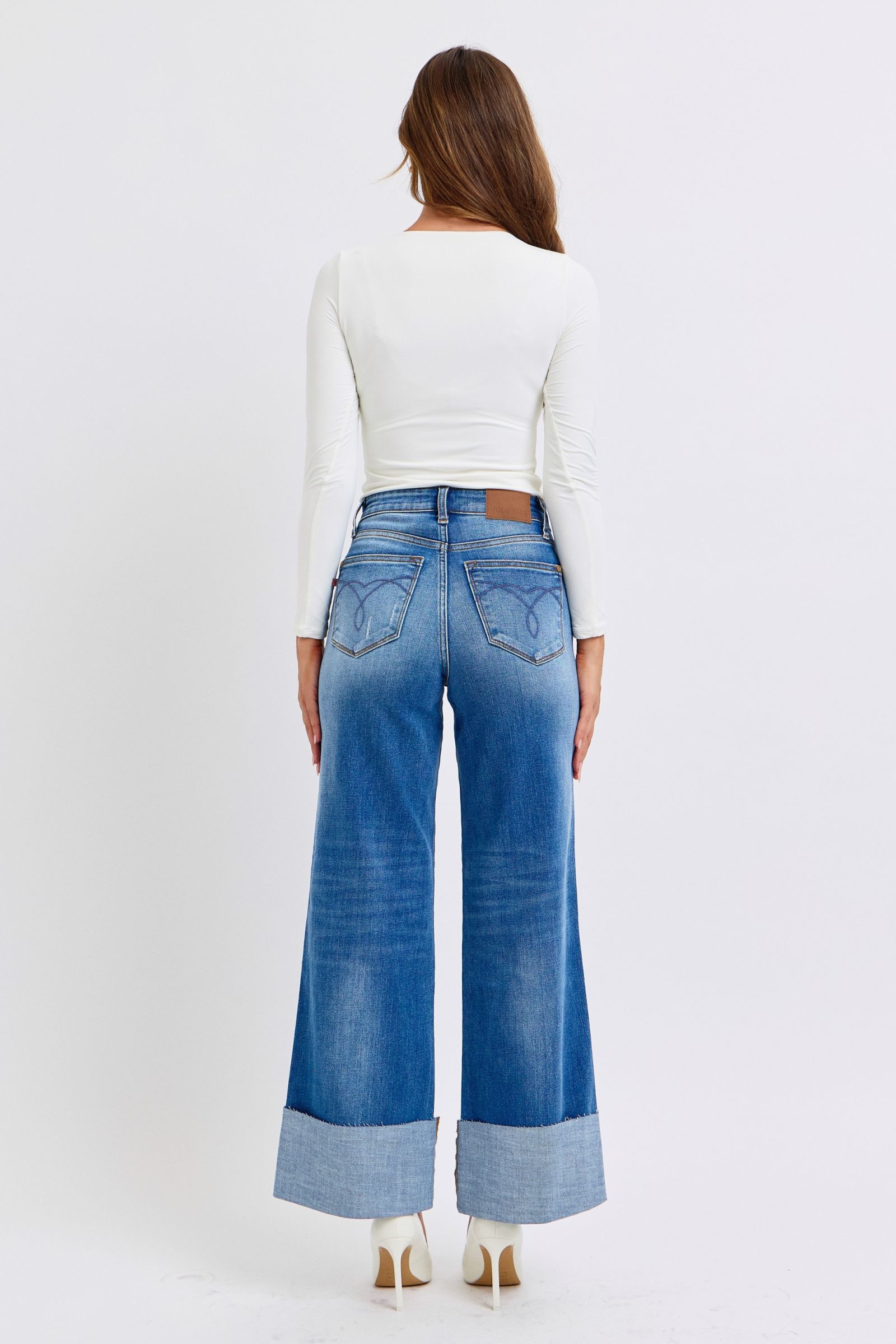 Judy Blue Full Size Distressed High Waist Wide Leg Jeans worn from the back, showing wide-leg fit and distressed detailing.