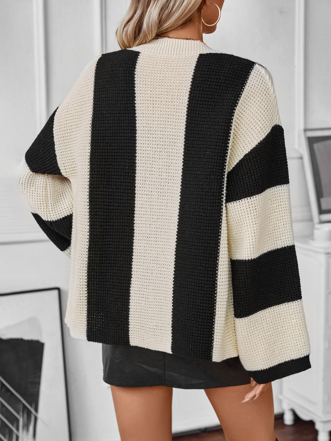 Waffle-knit black and white striped long sleeve cardigan.