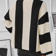 Waffle-knit black and white striped long sleeve cardigan.