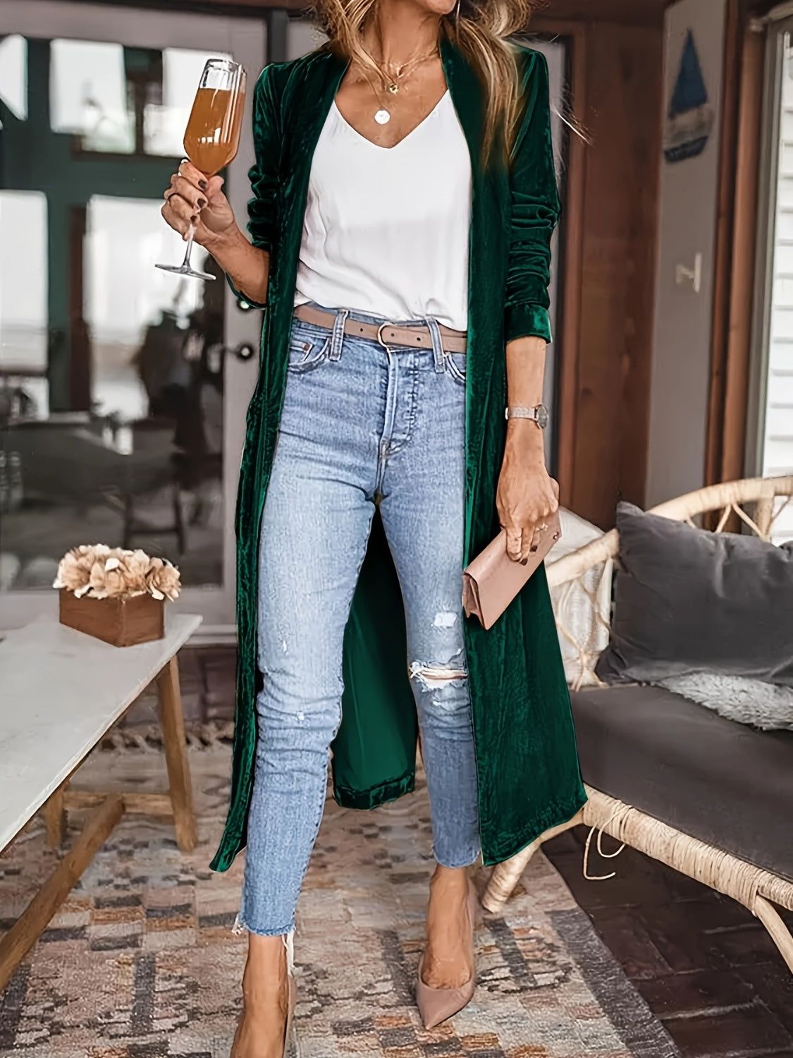 Open front long sleeve coat in dark green, featuring a slit design, styled with jeans and a white top.