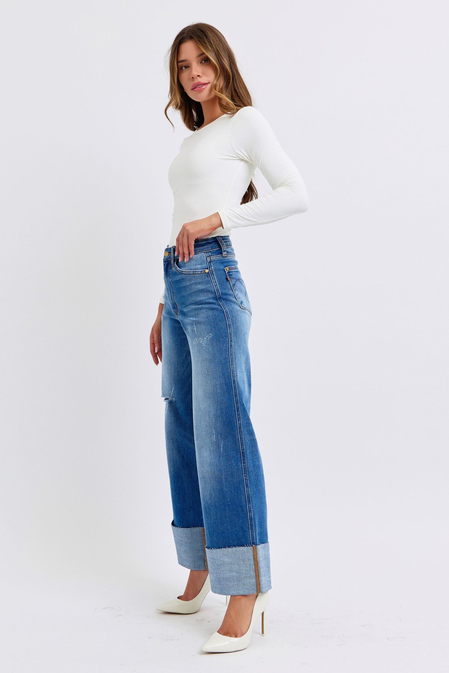 Judy Blue Full Size Distressed High Waist Wide Leg Jeans with white top and heels.