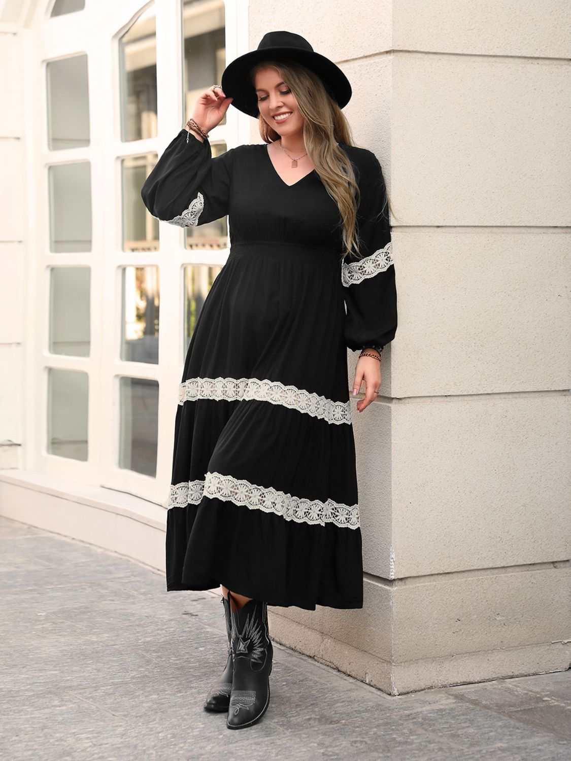 Plus size black V-neck long sleeve midi dress with lace details.