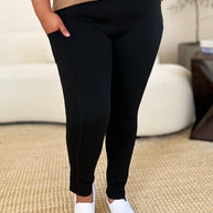 Wide waistband sports leggings in black with stretchy, opaque fabric.