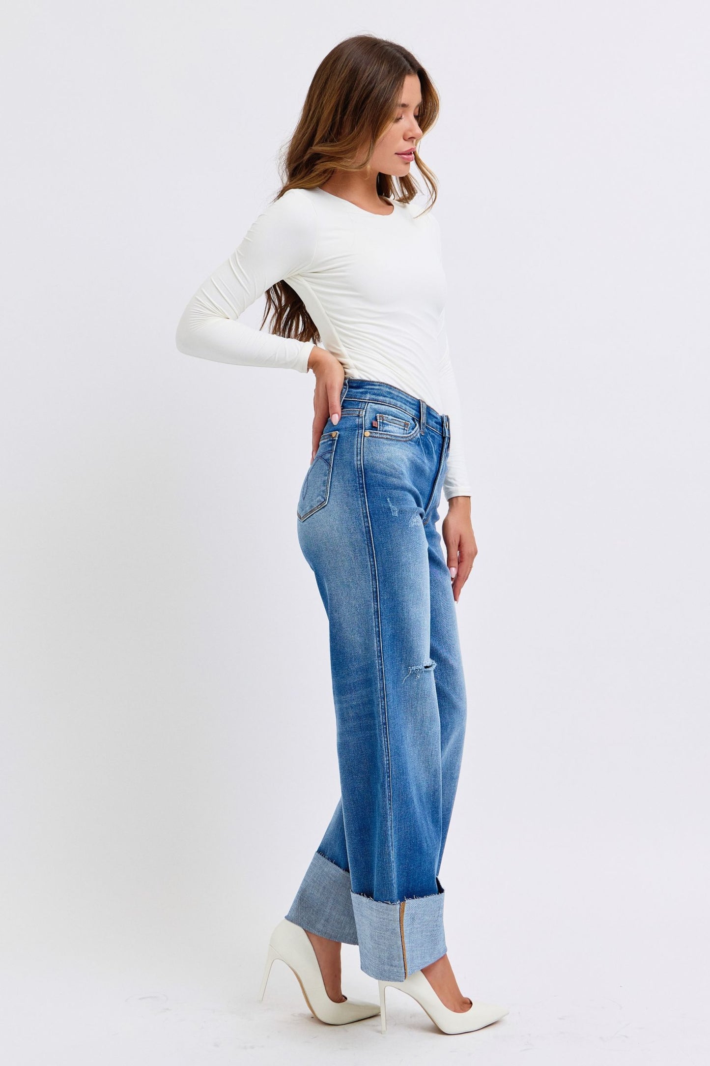 Judy Blue distressed high waist wide leg jeans with rolled cuffs, side profile.