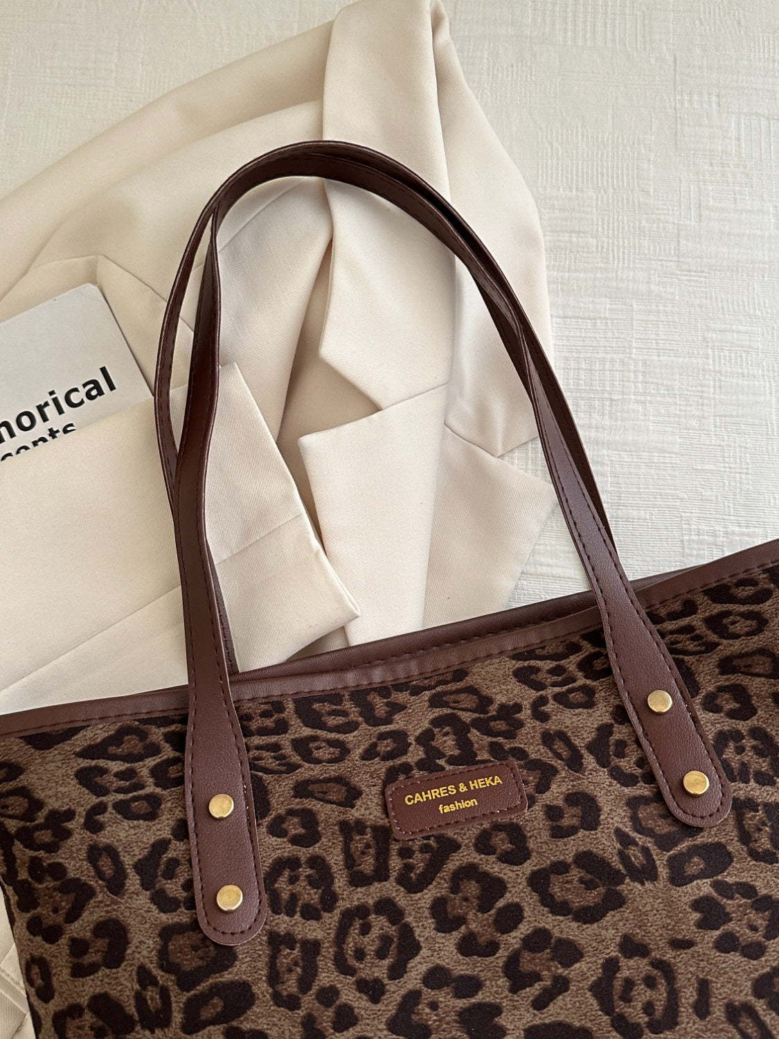 Leopard polyester tote bag with brown handles and pattern, large size.