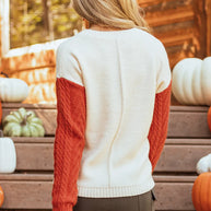 Color block round neck long sleeve sweater with red and white design, slightly stretchy, pocketed.