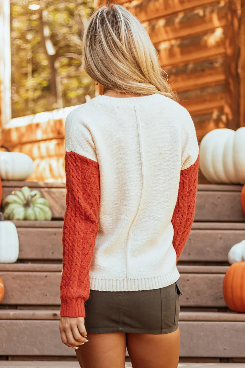 Color block round neck long sleeve sweater with red and white design, slightly stretchy, pocketed.