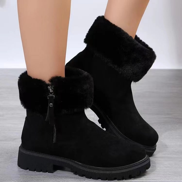 Suede faux fur boots with side zipper and low heels.