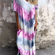 Full size pocketed tie-dye short sleeve dress with purple and blue patterns.