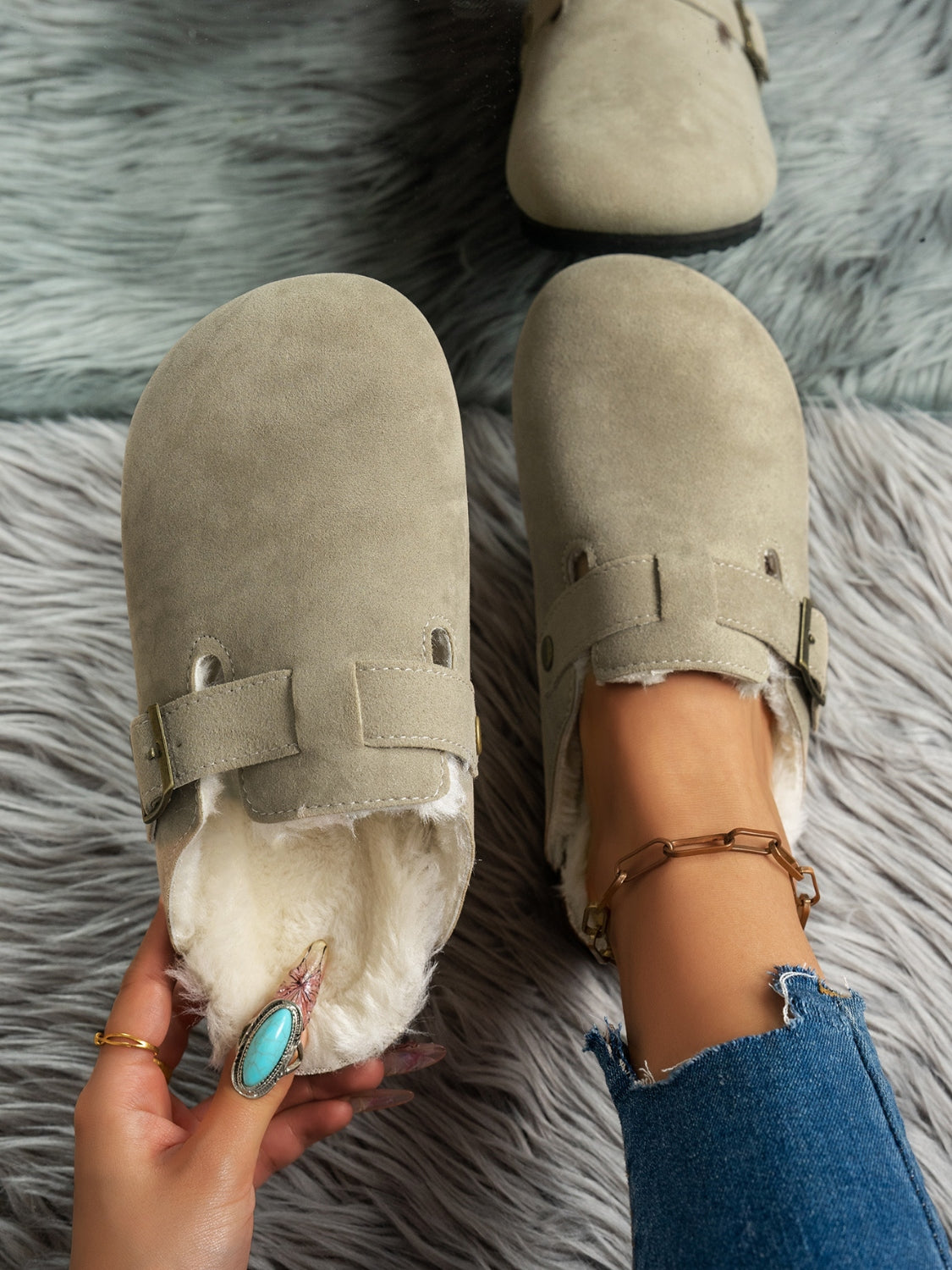 Suede round toe slippers with faux fur lining and rubber sole.