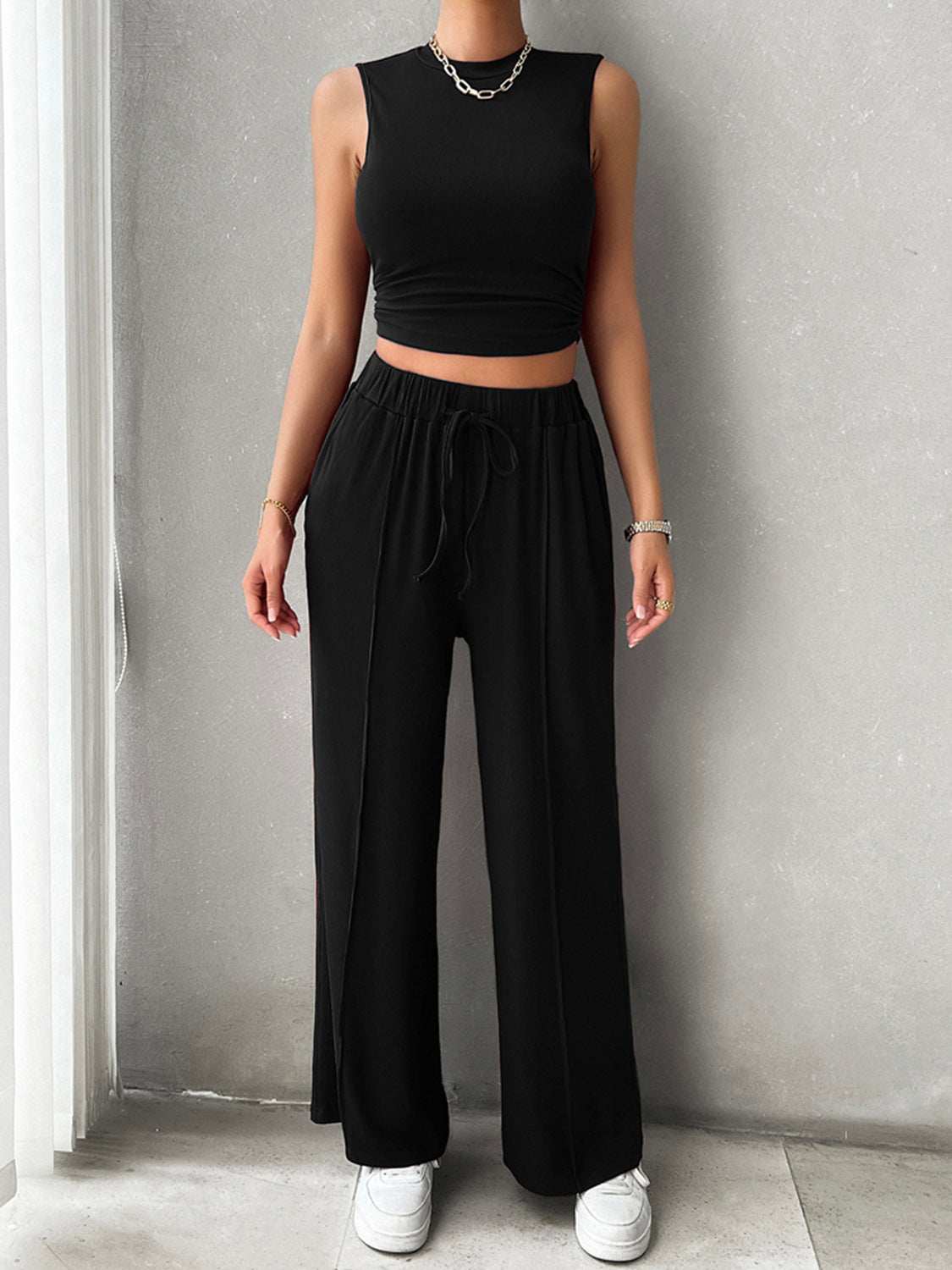 Devine Mock Neck Sleeveless Top and Drawstring Pants Set in black, highly stretchy, pocketed design.