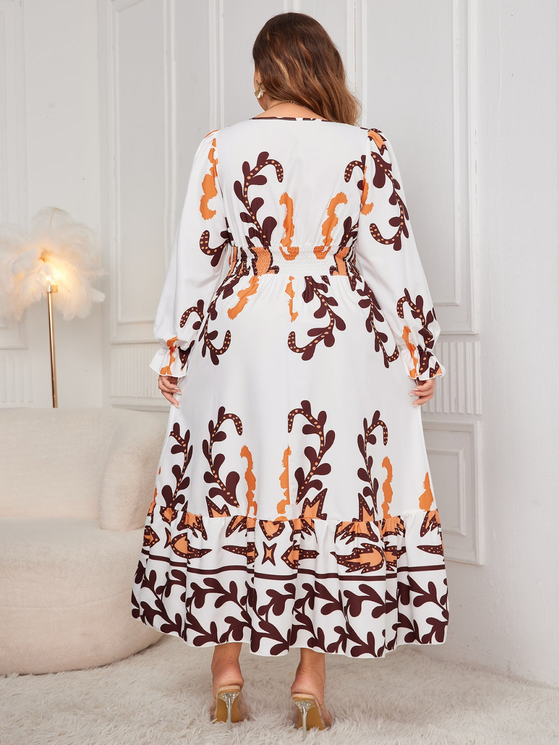 Plus size printed surplice dress with flounce sleeves, back view.