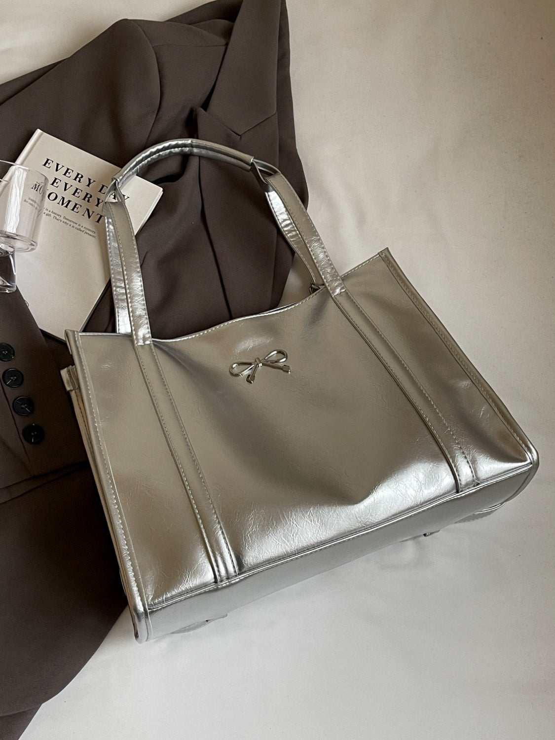 PU Leather Bow Shoulder Bag in metallic finish, spacious design.