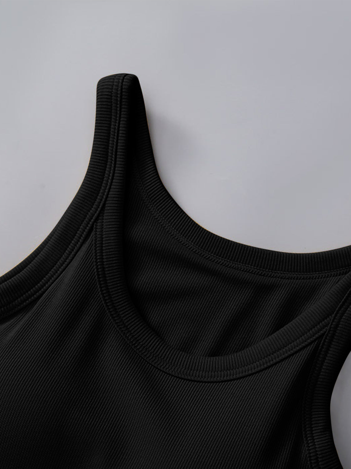 Round neck black tank with built-in bra, opaque and moderately stretchy.