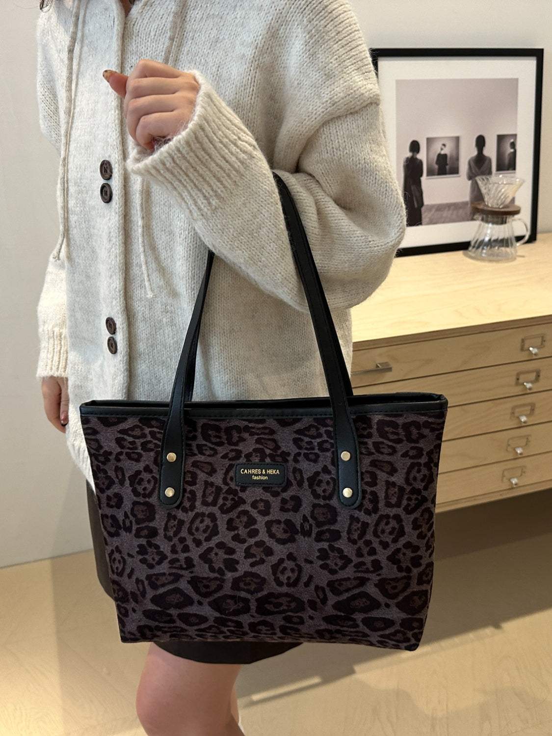 Leopard print polyester tote bag in large size with black handles.