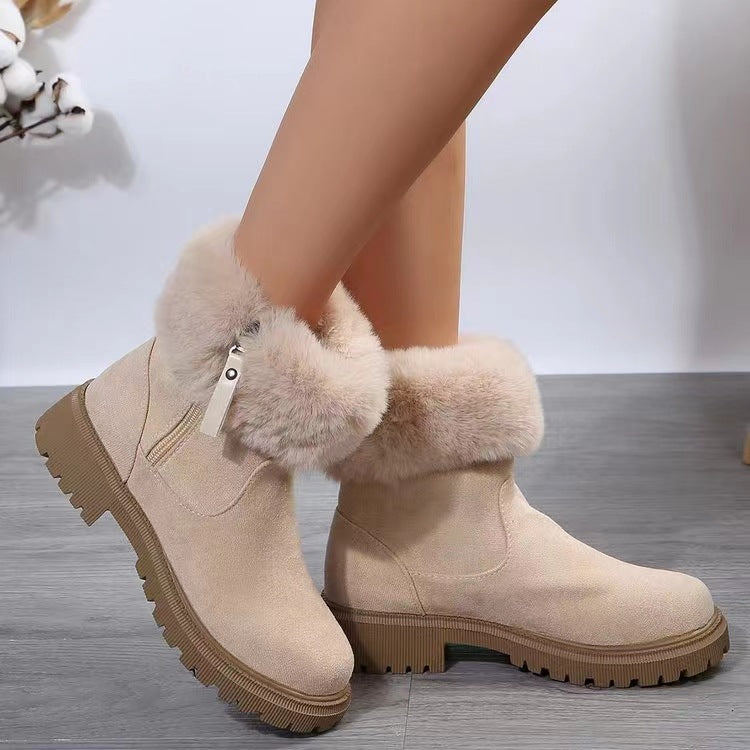 Suede faux fur boots with side zipper and low heels.