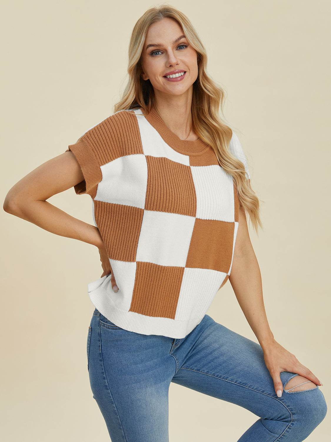 Woman wearing a full size checkered round neck short sleeve sweater in brown and white.