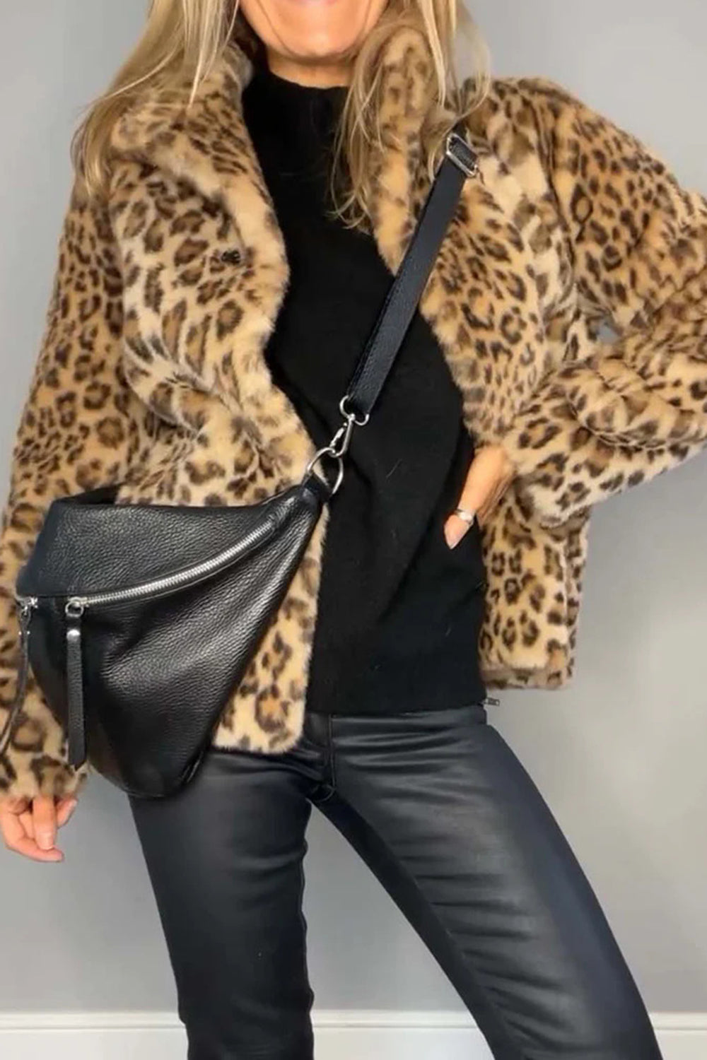 Leopard print furry coat with collared neck and long sleeves.