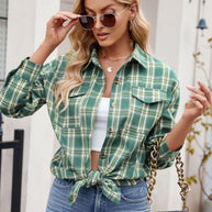 Plaid button-up shirt with long sleeves, buttoned pockets, and a tied front style.