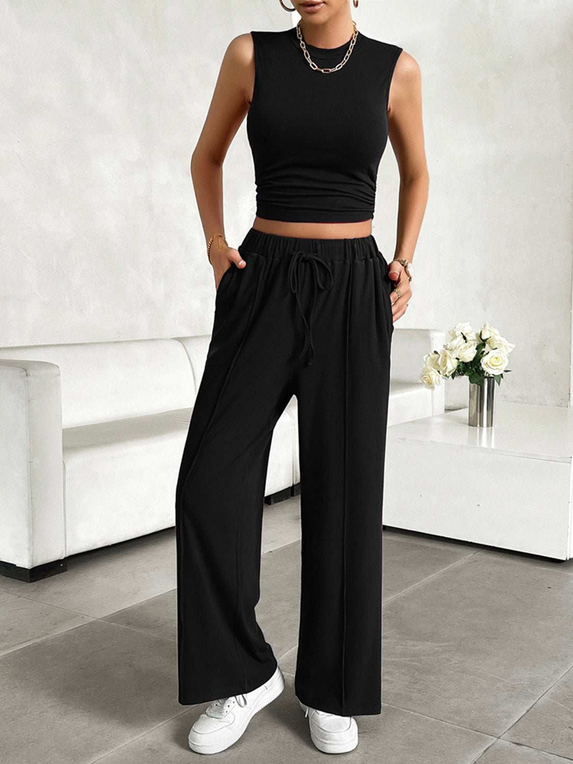 Devine Mock Neck Sleeveless Top and Drawstring Pants Set in black, featuring a stretchy fabric with pocketed design and drawstring waist.