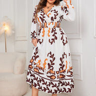 Plus size printed surplice flounce sleeve dress with ruffled details in white and brown.