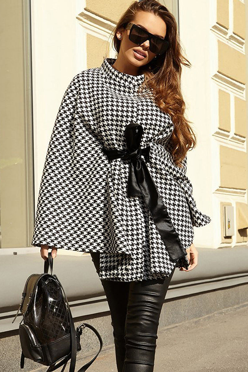 Houndstooth tie waist trench coat with relaxed fit and black belt.