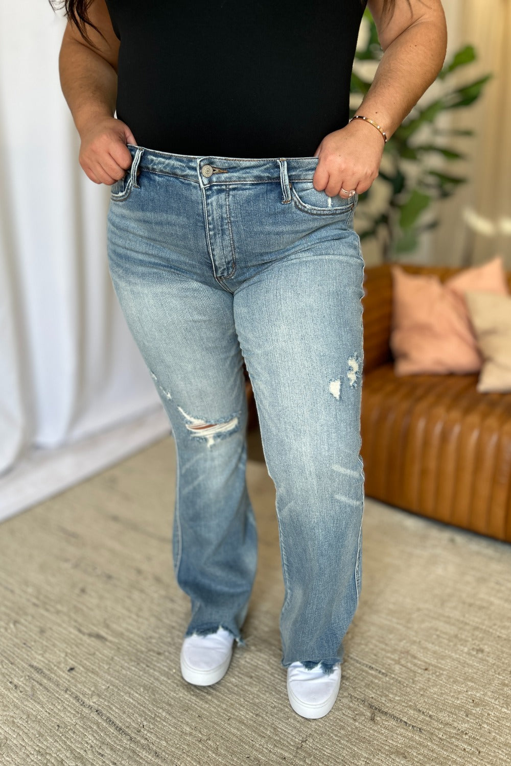 Judy Blue Full Size Medium Rise Tummy Control Destroy Flare jeans with distressed detailing and raw hem.