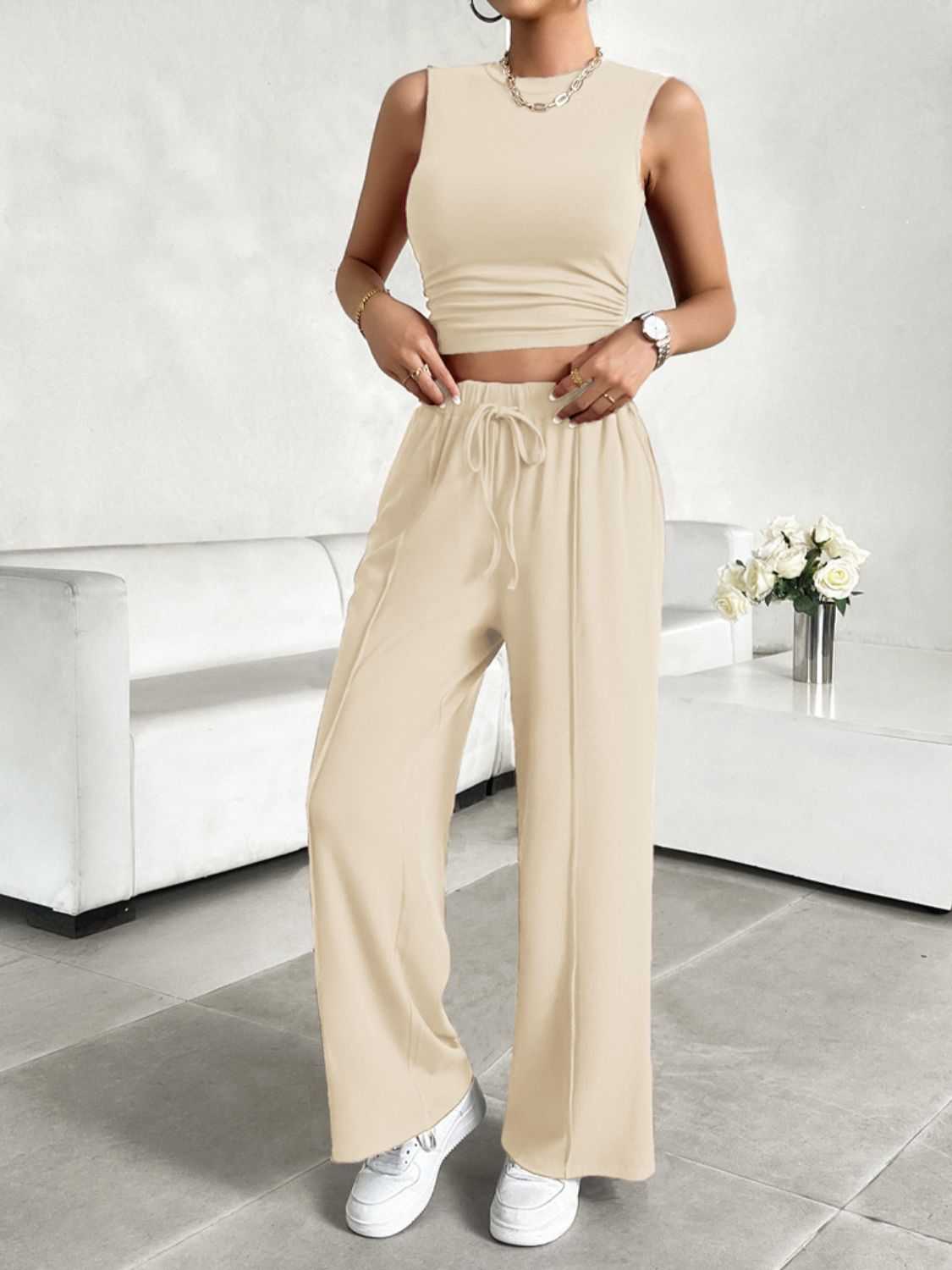 Devine Mock Neck Sleeveless Top and Drawstring Pants Set in beige with stretchy fabric, ideal for all-day wear.