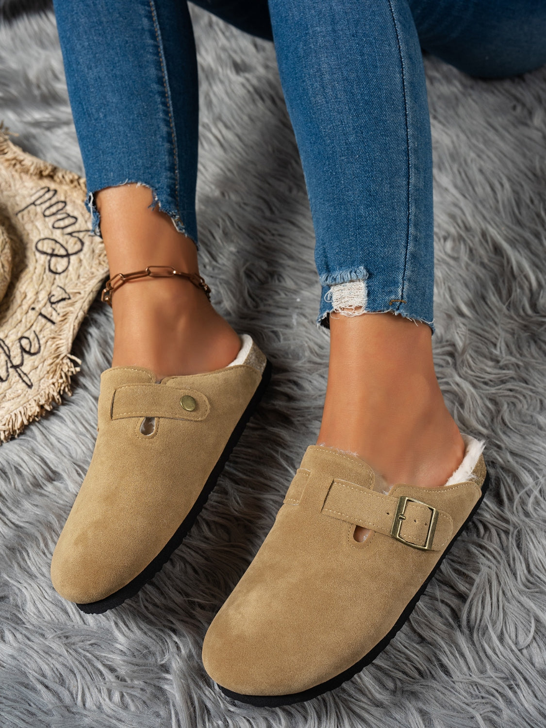 Suede round toe slippers with faux fur lining and rubber sole.