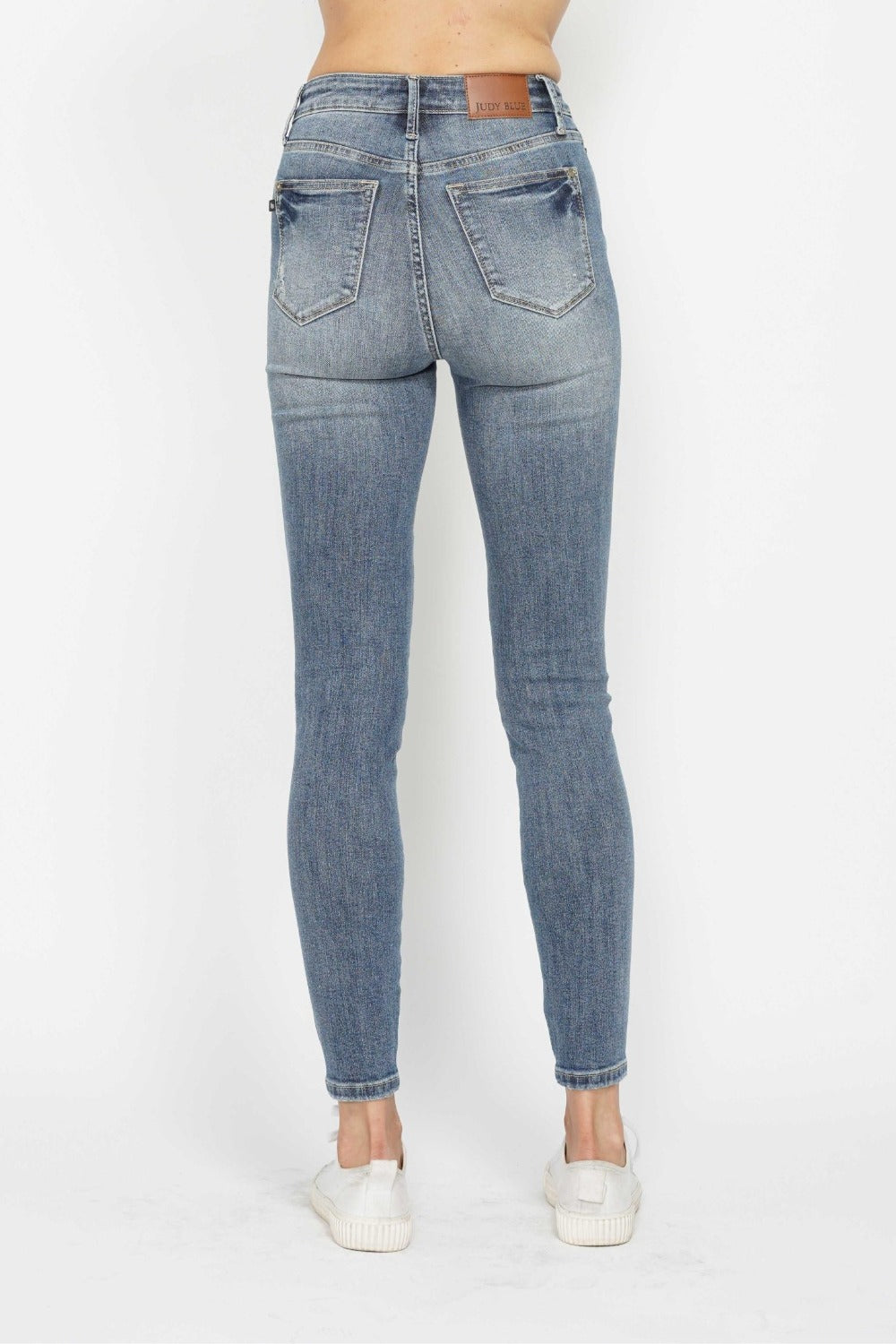 Judy Blue full size tummy control contrast wash skinny jeans, back view, showcasing stretch denim and flattering fit.