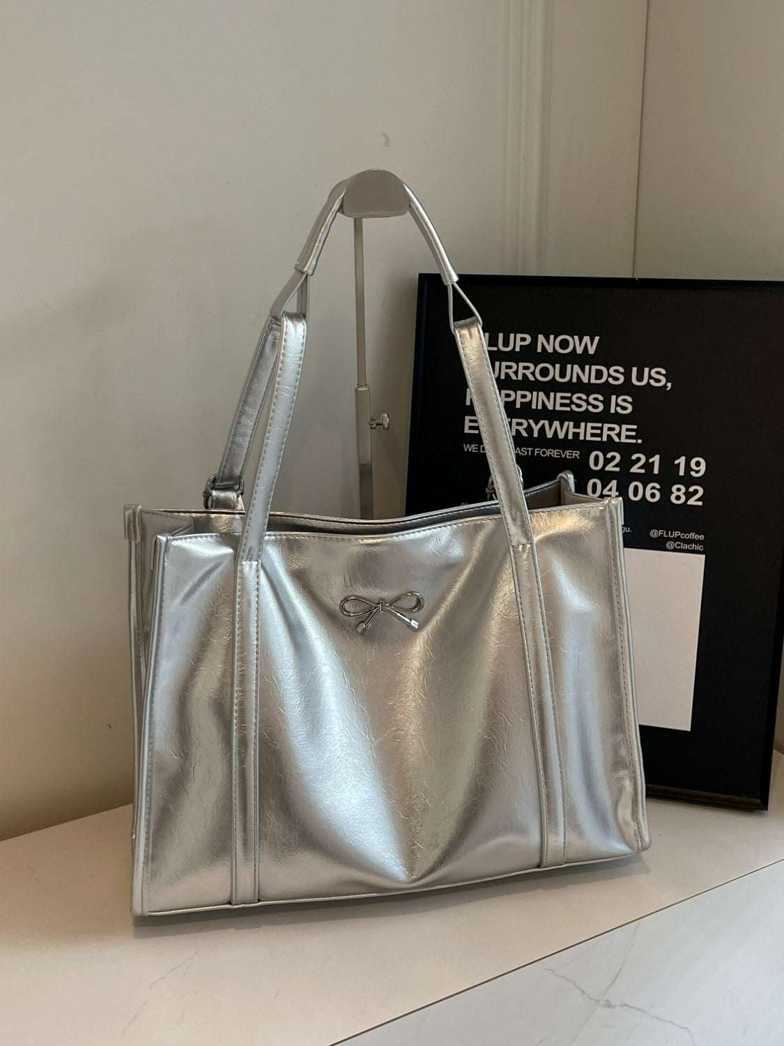 PU Leather Bow Shoulder Bag in metallic silver, spacious and durable.