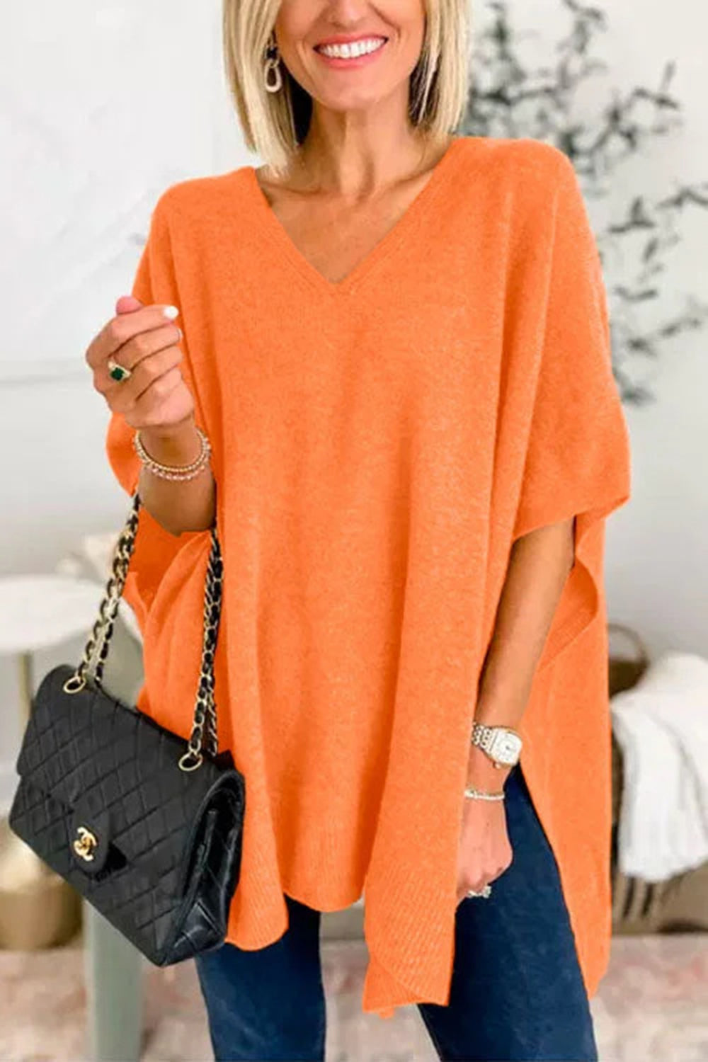 Vibrant slit V-neck half sleeve knit top in orange.