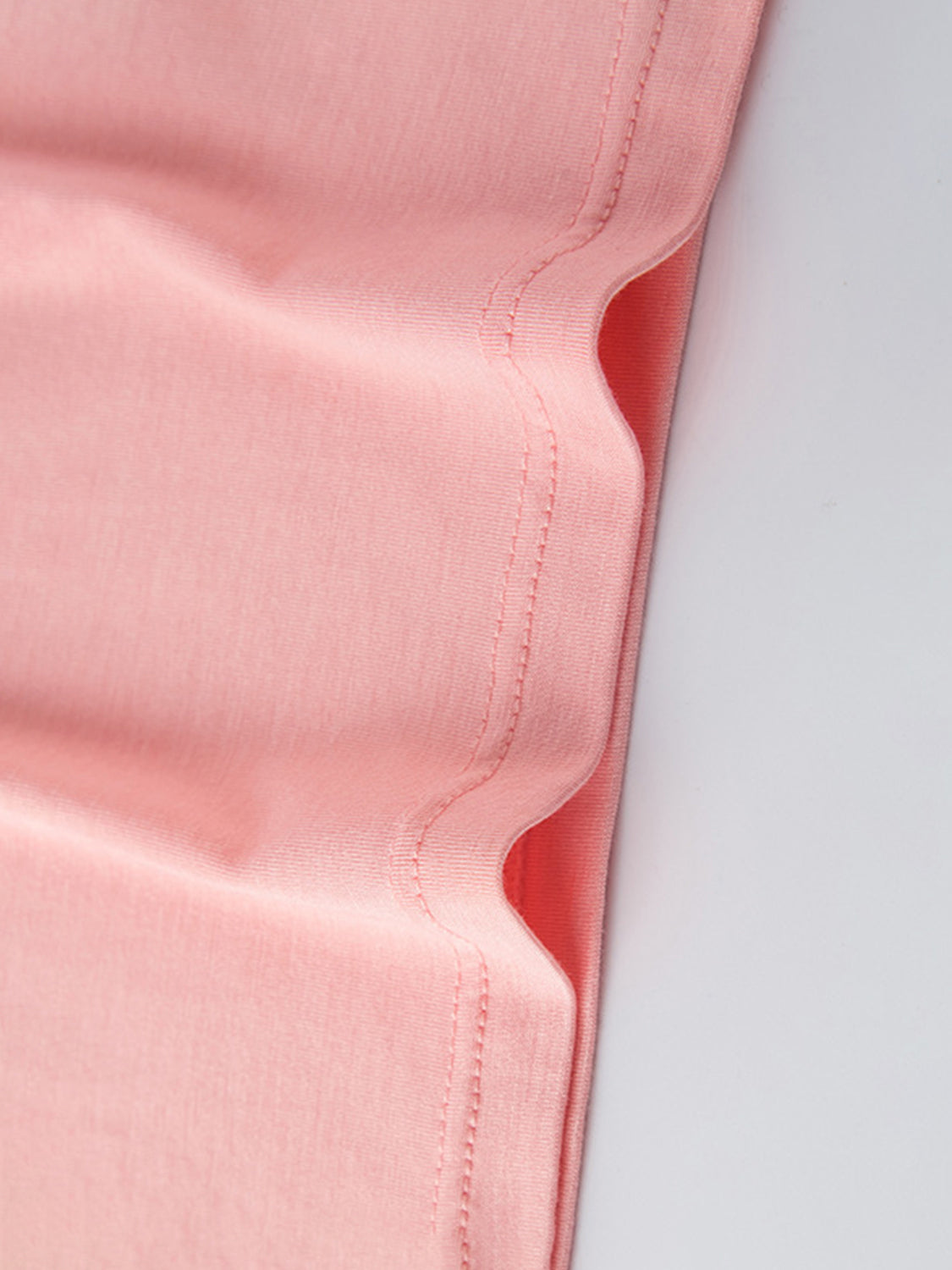 Round neck wide strap mini tank dress fabric close-up in pink.