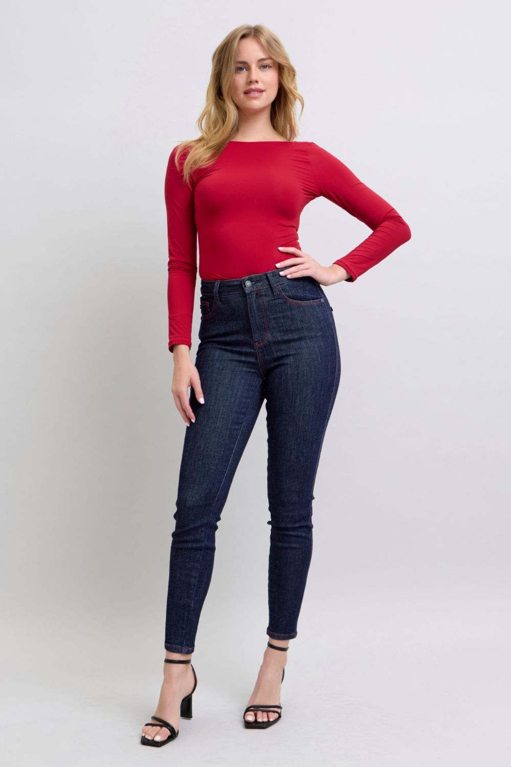 Judy Blue high-rise skinny jeans with heart-shaped back pockets, paired with a red top.