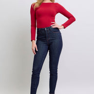 Judy Blue high-rise skinny jeans with heart-shaped back pockets, paired with a red top.