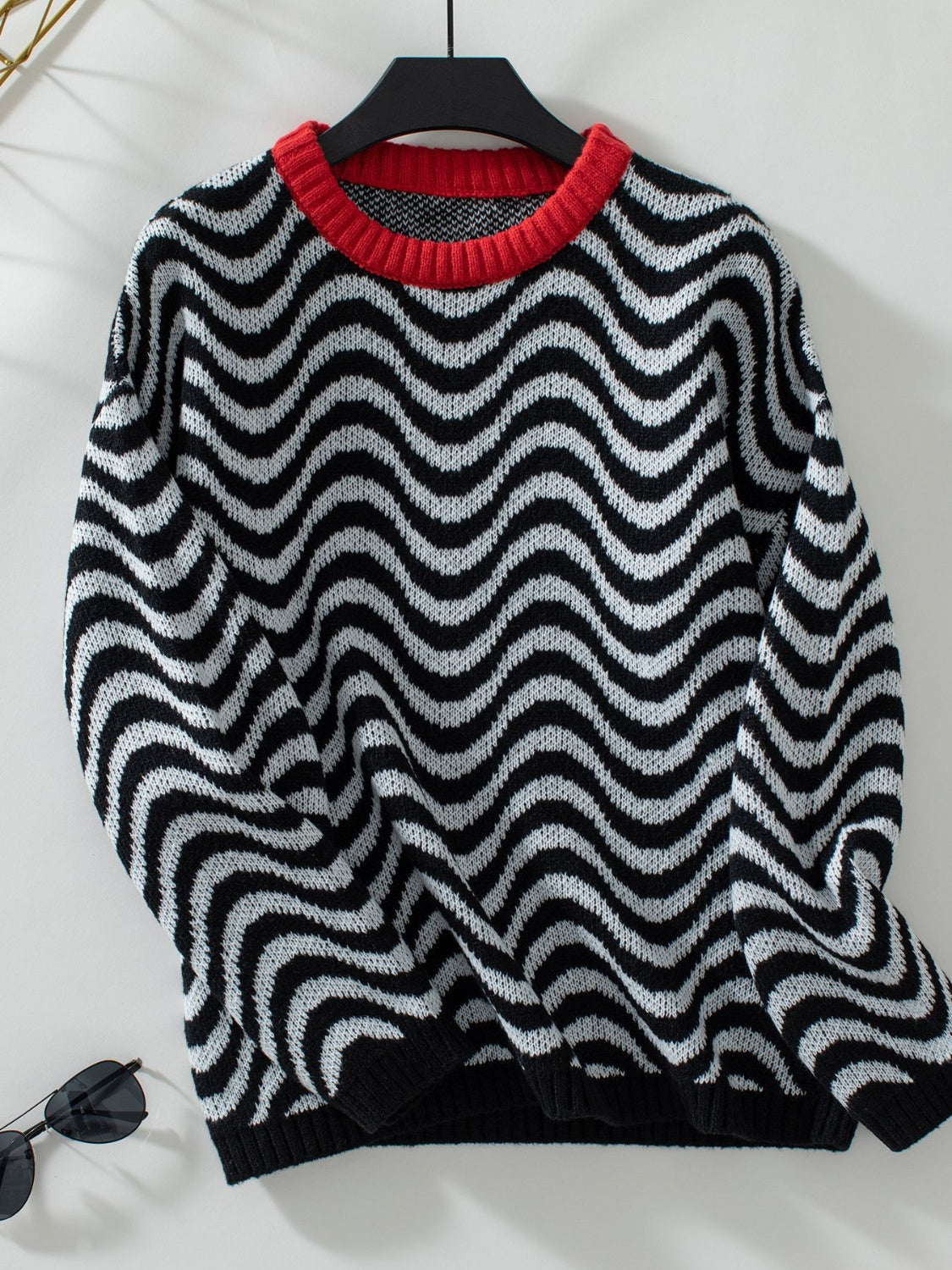 Wavy Stripes Round Neck Long Sleeve Sweater with black and white pattern on a hanger.