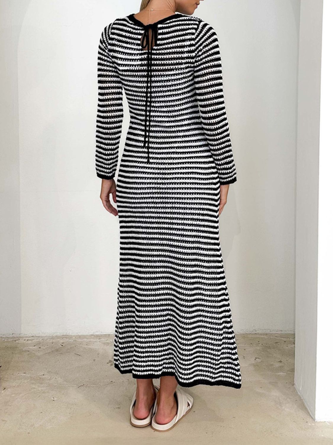 Devine Tied Round Neck Striped Sweater Dress in black and white with moderate stretch, made of 100% viscose.