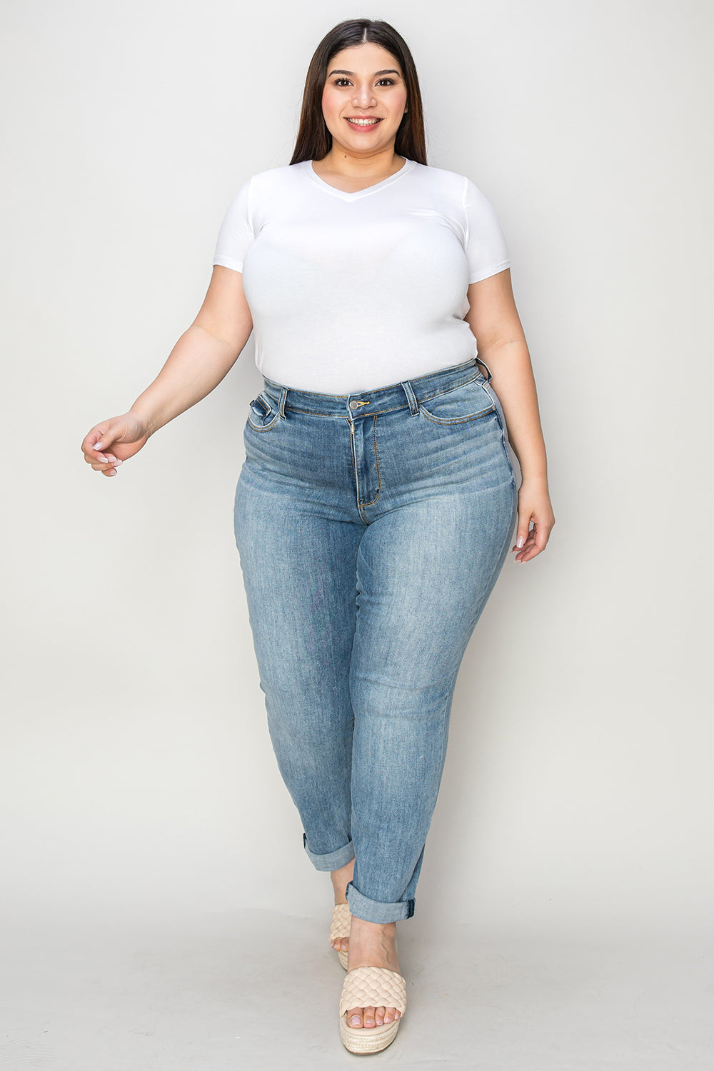 Judy Blue Full Size Cuffed Hem Slim Jeans worn by a model, demonstrating a flattering fit and modern style with versatile cuffed hem detail.