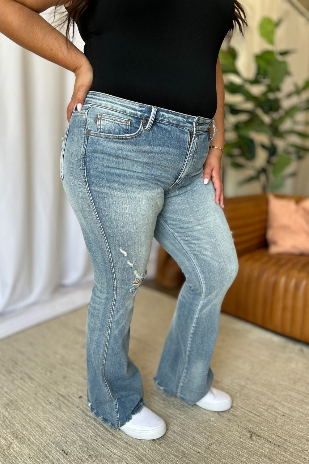 Judy Blue Medium Rise Tummy Control Flare Jeans with Distressed Detailing.