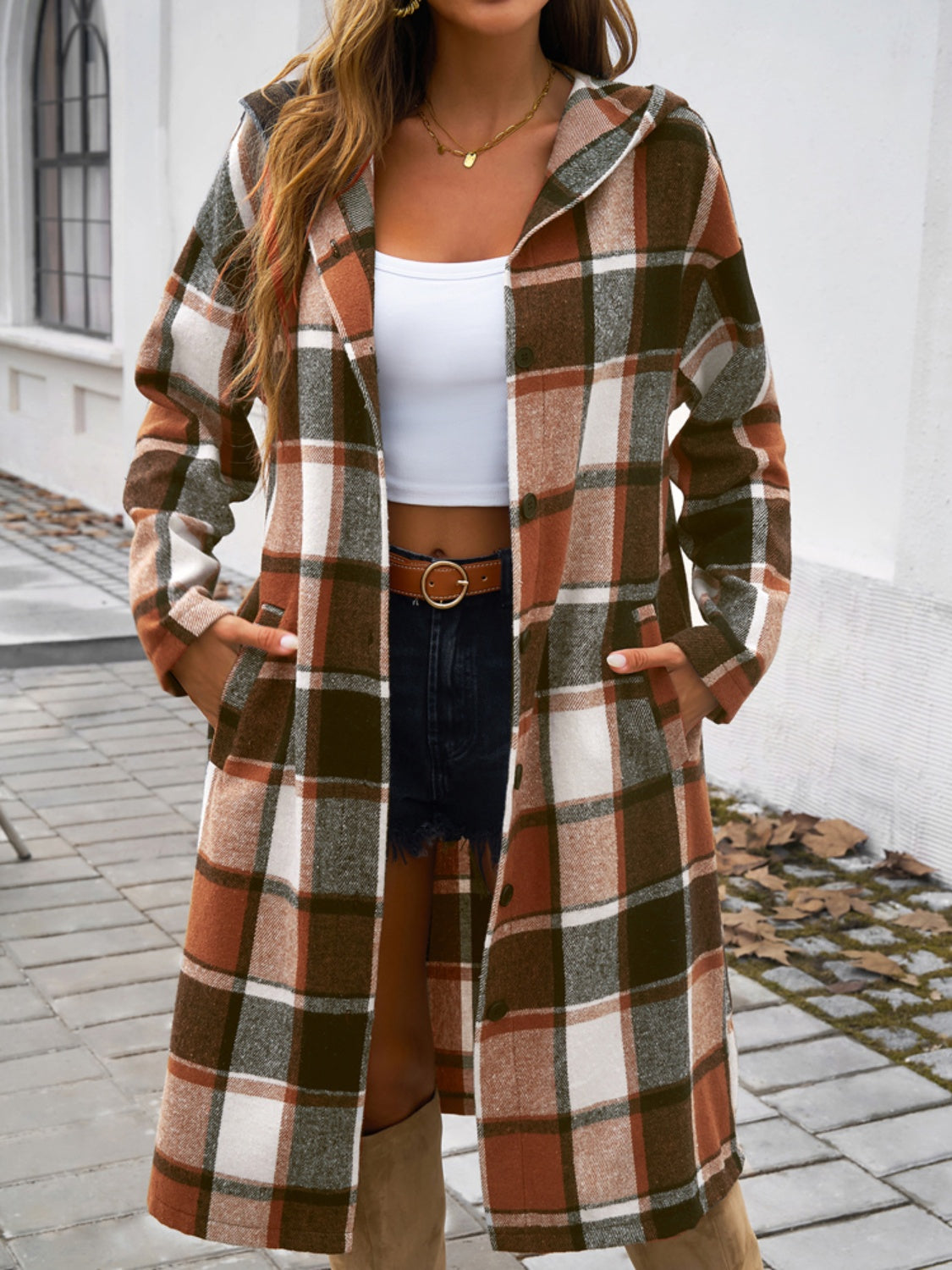 Plaid long sleeve hooded coat with button closure and pockets.